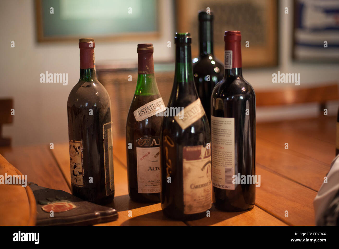 Dusty wine bottles on table wooden table Stock Photo