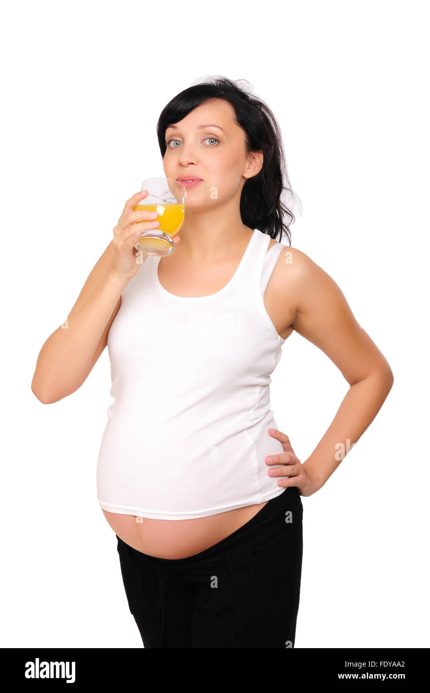 Young pregnant woman drinking orange juice with pleasure Stock Photo ...