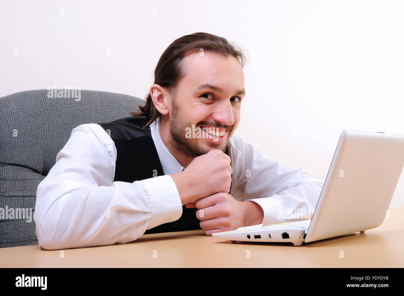 A young business man working on the computer in the office Stock Photo ...