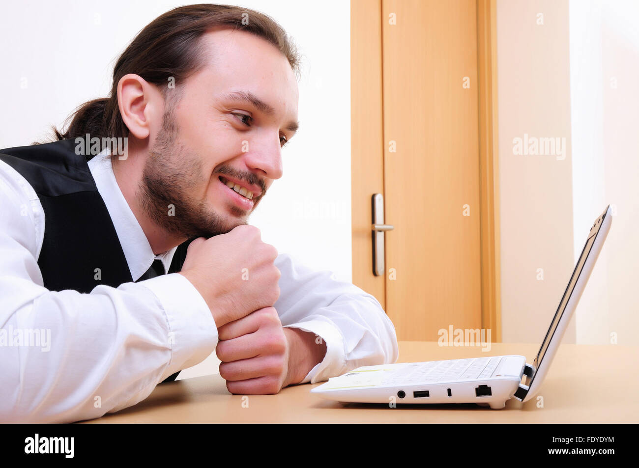 A young business man working on the computer in the office Stock Photo ...