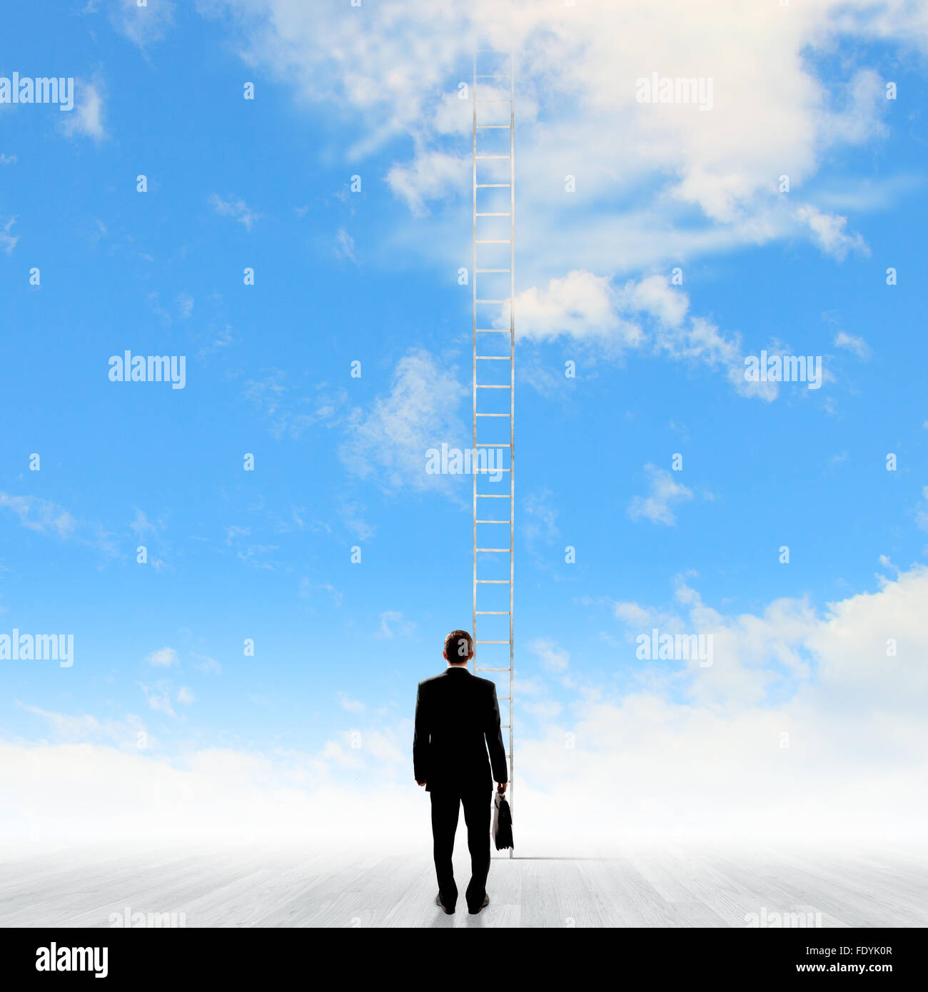 Rear view of businessman standing near ladder going high in sky Stock ...