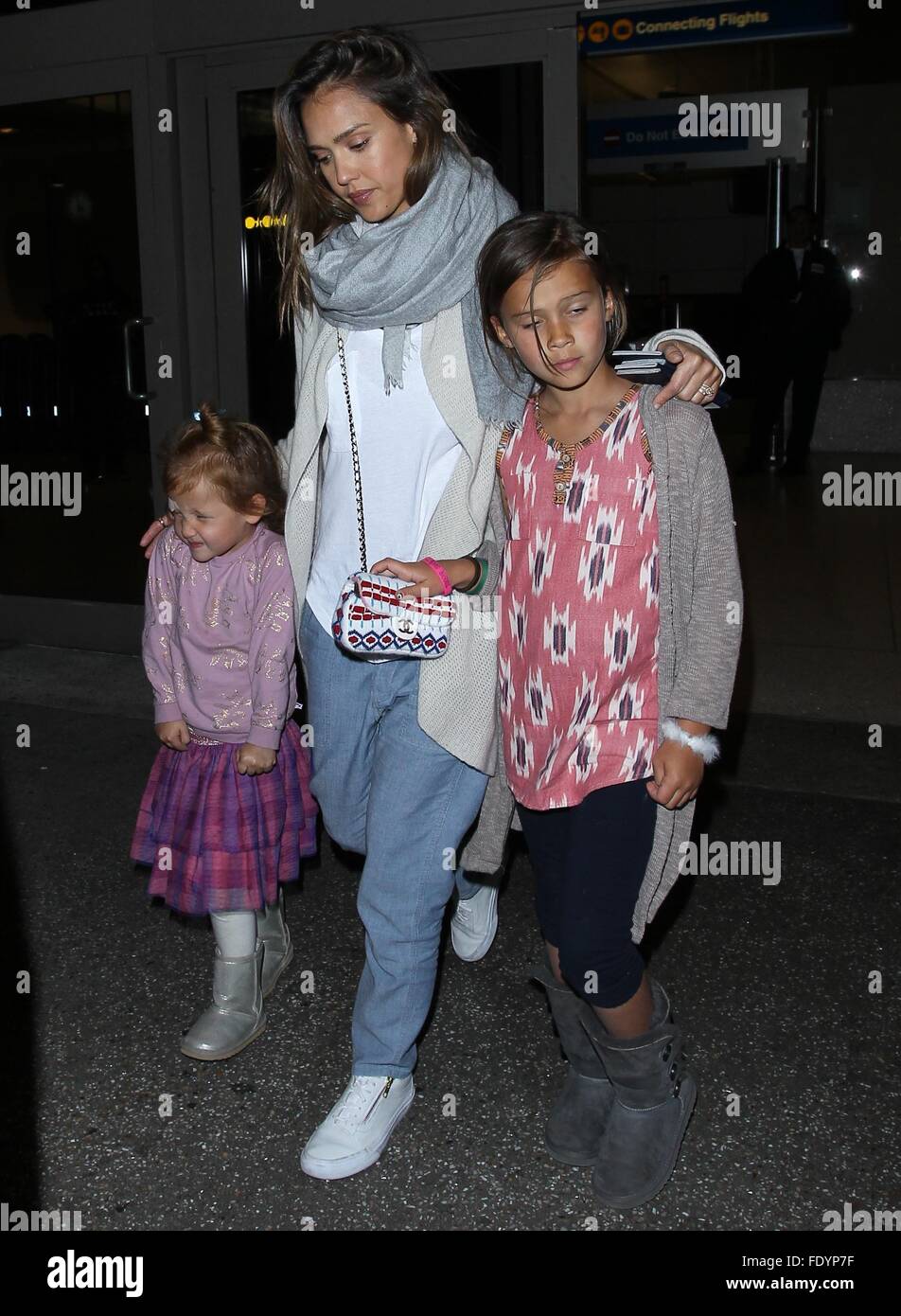 Jessica Alba and Cash Warren arrive at Los Angeles International (LAX) Airport with their two daughters. Cash arrived at the airport with the assistance of crutches.  Featuring: Jessica Alba, Honor Marie Warren, Haven Garner Warren Where: Los Angeles, Cal Stock Photo