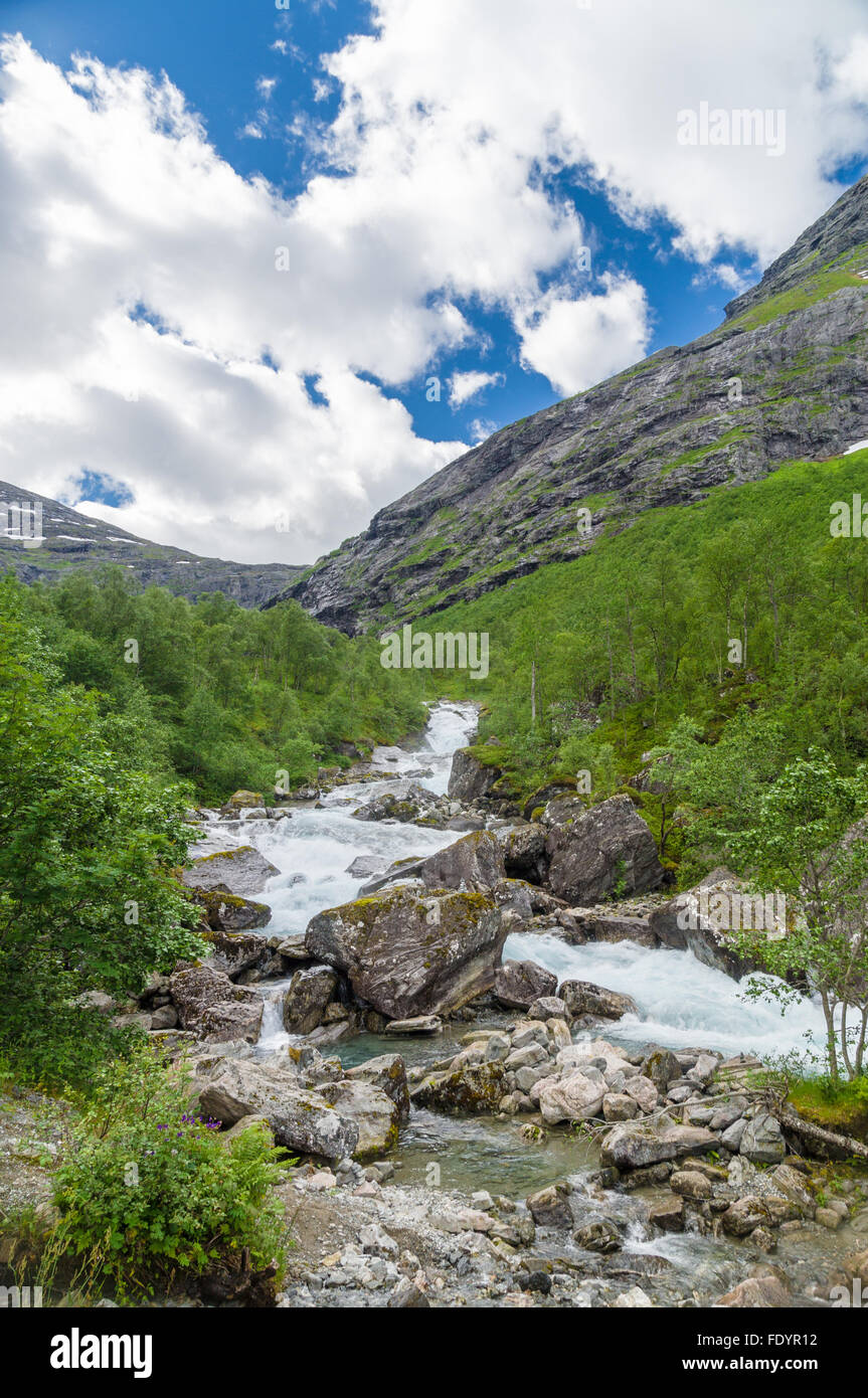 Rapid river flowing between stones and boulders Stock Photo