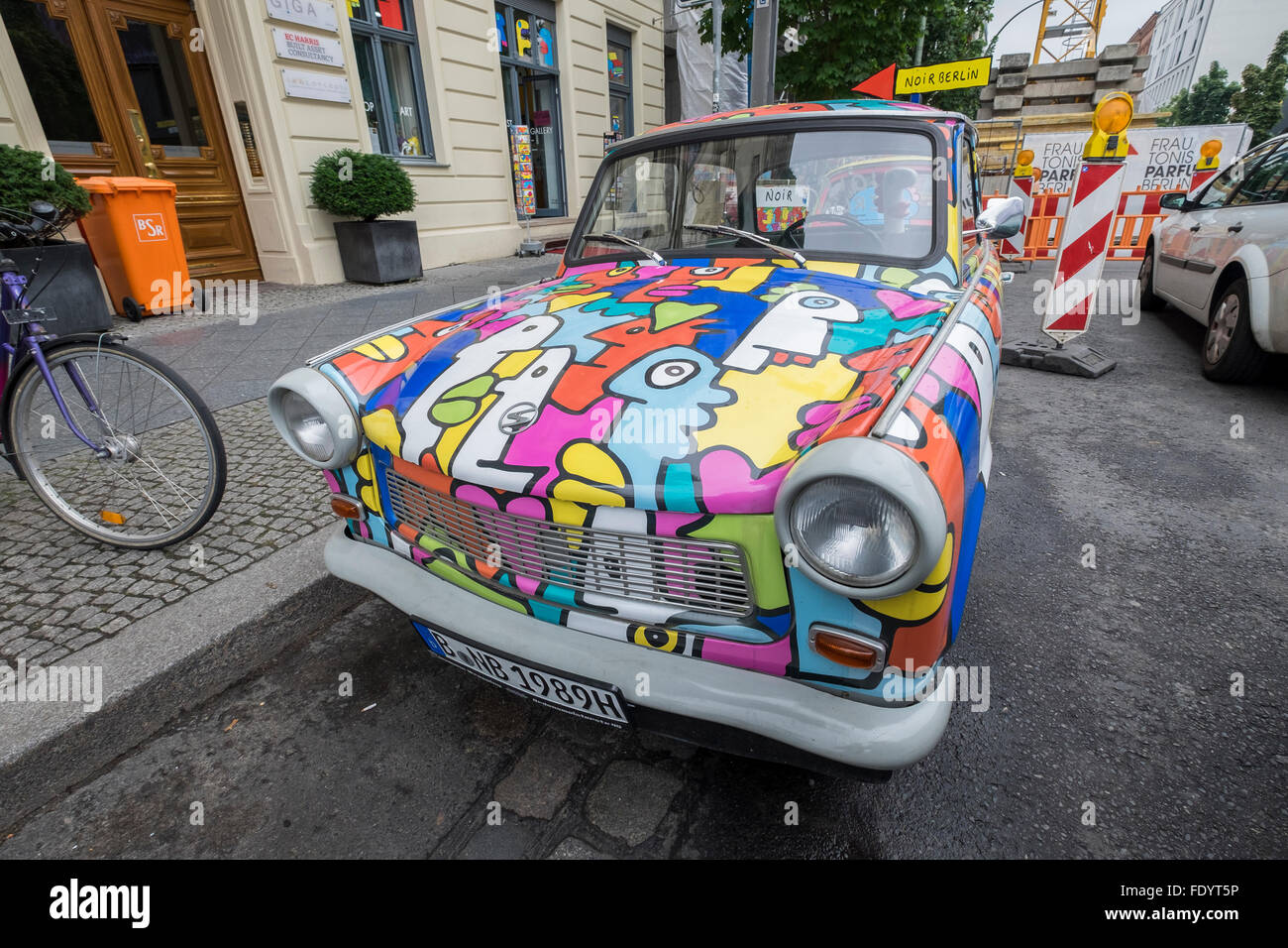 A brightly painted Trabant motor car parked in Berlin, Germany. Stock Photo