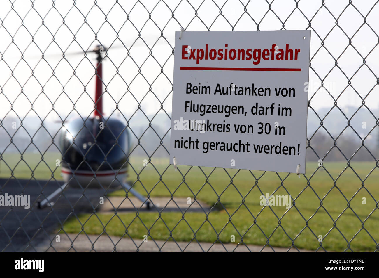 Beromuenster, Switzerland, sign -Explosionsgefahr- the fence of an airfield Stock Photo