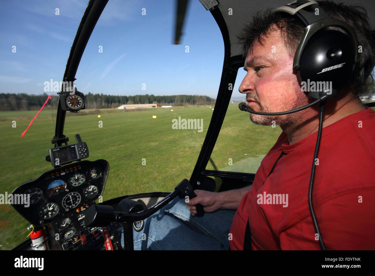 Beromuenster, Switzerland, helicopter pilot during a flight in the cockpit Stock Photo