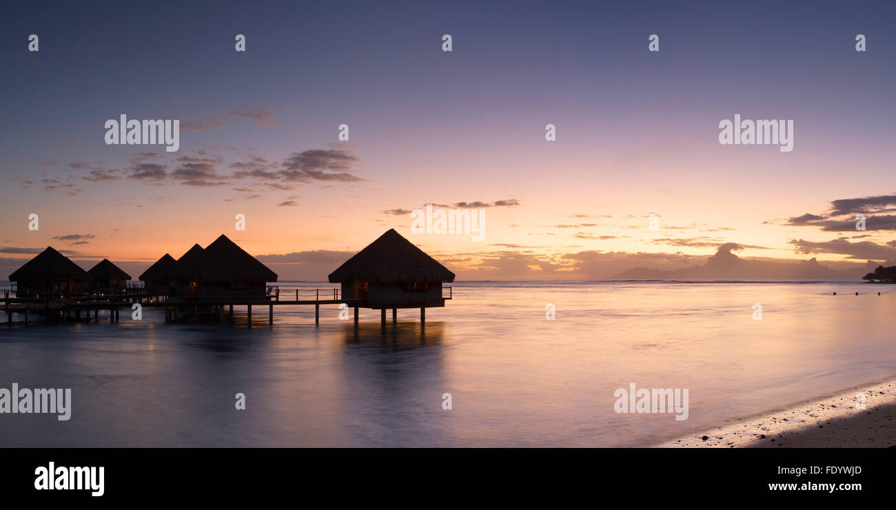 Overwater bungalows at Le Meridien Tahiti Hotel at sunset, Pape'ete, Tahiti, French Polynesia Stock Photo