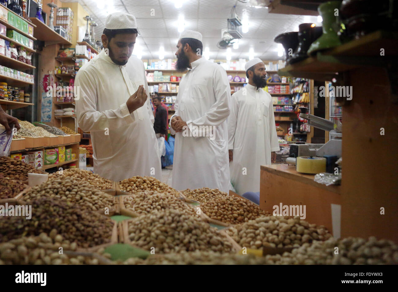 Dubai, United Arab Emirates, man looks at a grocery critical a nut Stock Photo
