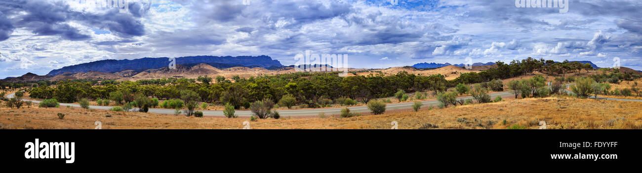 wide panoramic fiew towards mountain ranges of Flinders ranges national park and Wilpena Pound rock formation from flat land Stock Photo