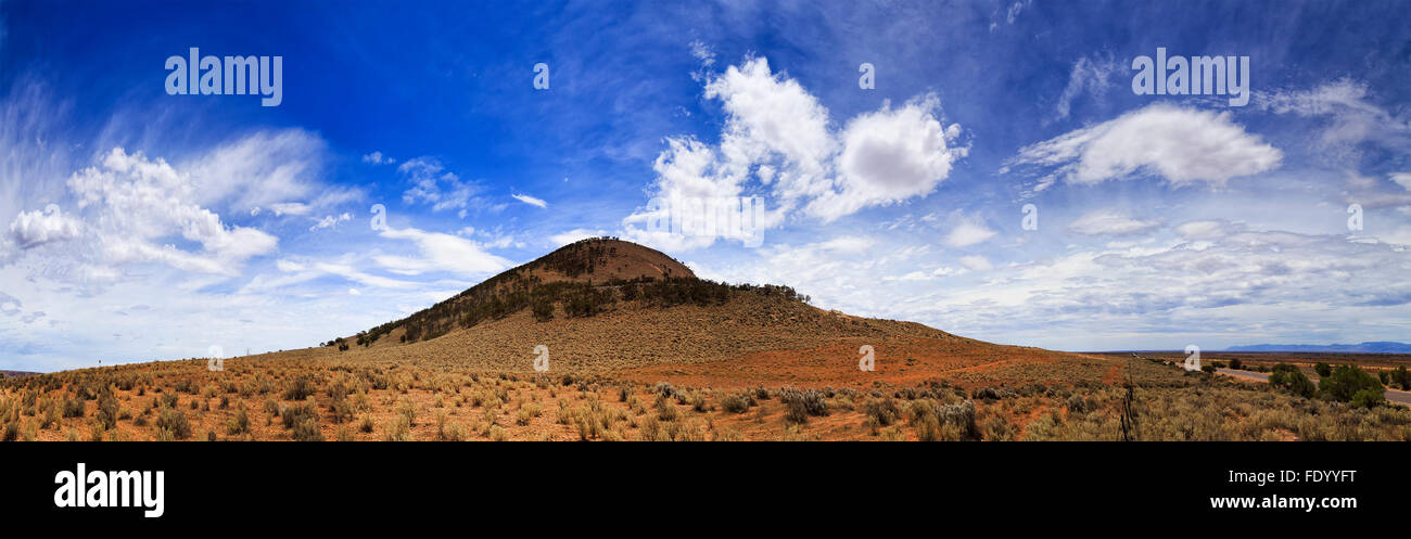 dry red remote plains of South Australia in Eyre Peninsula with single elevated hill on the horizon near Port Augusta on a sunny Stock Photo