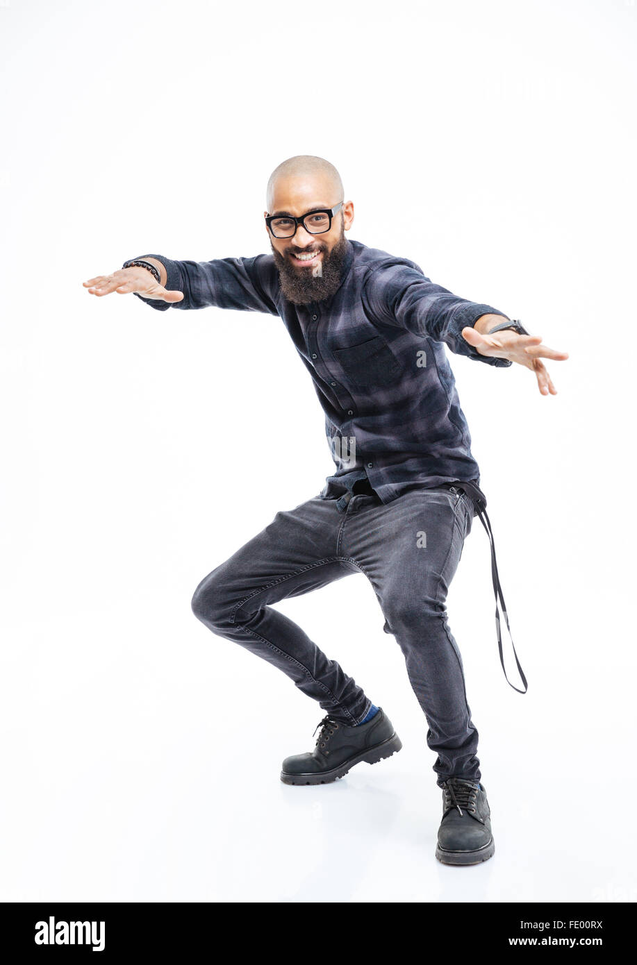 Happy african american young bearded man in glasses balancing and dancing Stock Photo