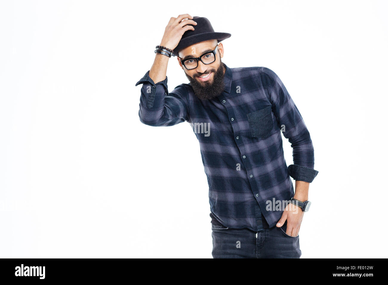 Happy bearded young african man in black hat and glasses standing and