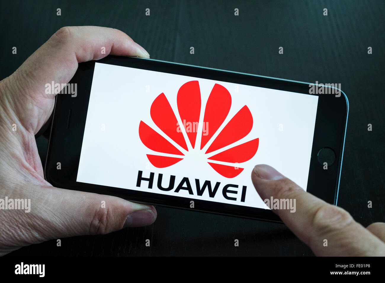 Huawei Chinese electronics company website logo showing on iPhone 6 Plus smart phone Stock Photo