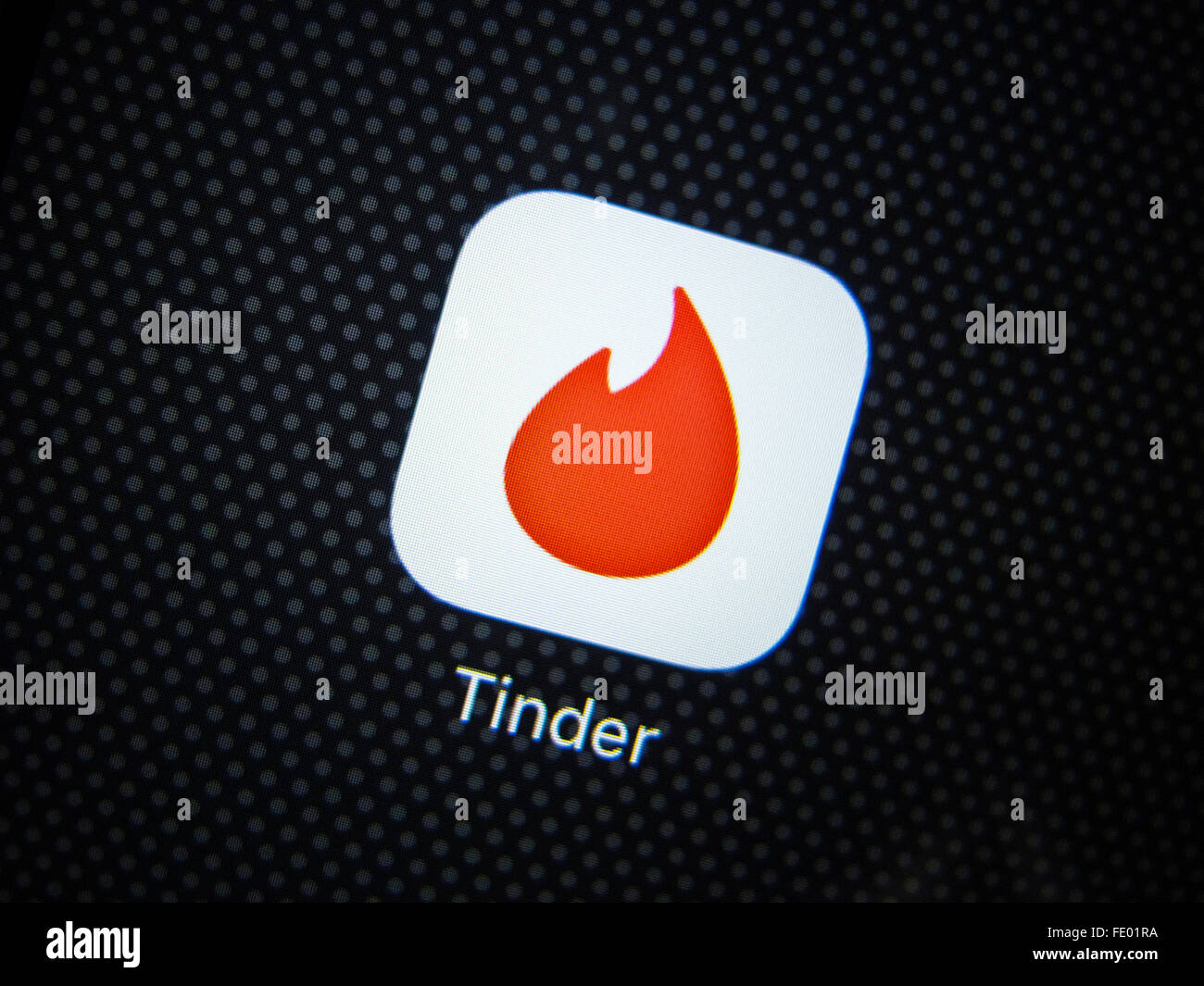 Tinder dating app logo on an iPhone smart phone Stock Photo