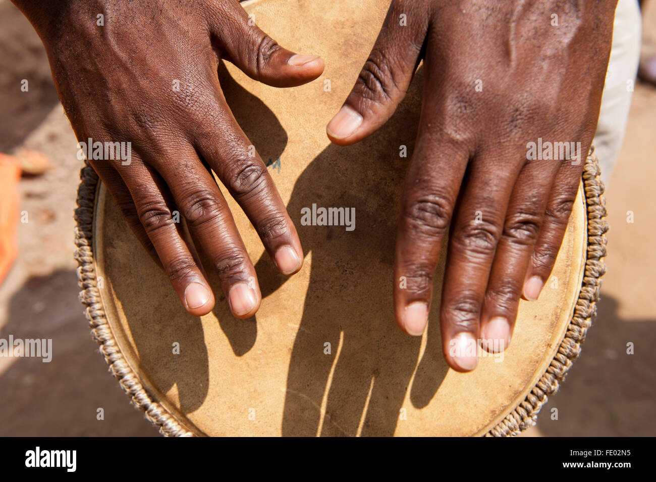 Playing traditional hand drums in Uganda Stock Photo Alamy