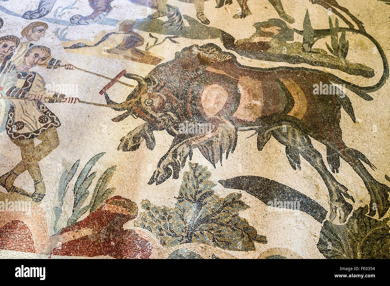 Roman mosaic of men with a bull in Villa Romana del Casale, Piazza Armerina, Sicily, Italy Stock Photo