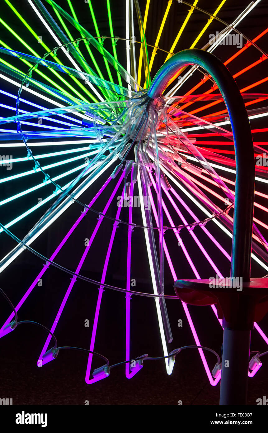 View of umbrella structure composed of neon tubes Stock Photo