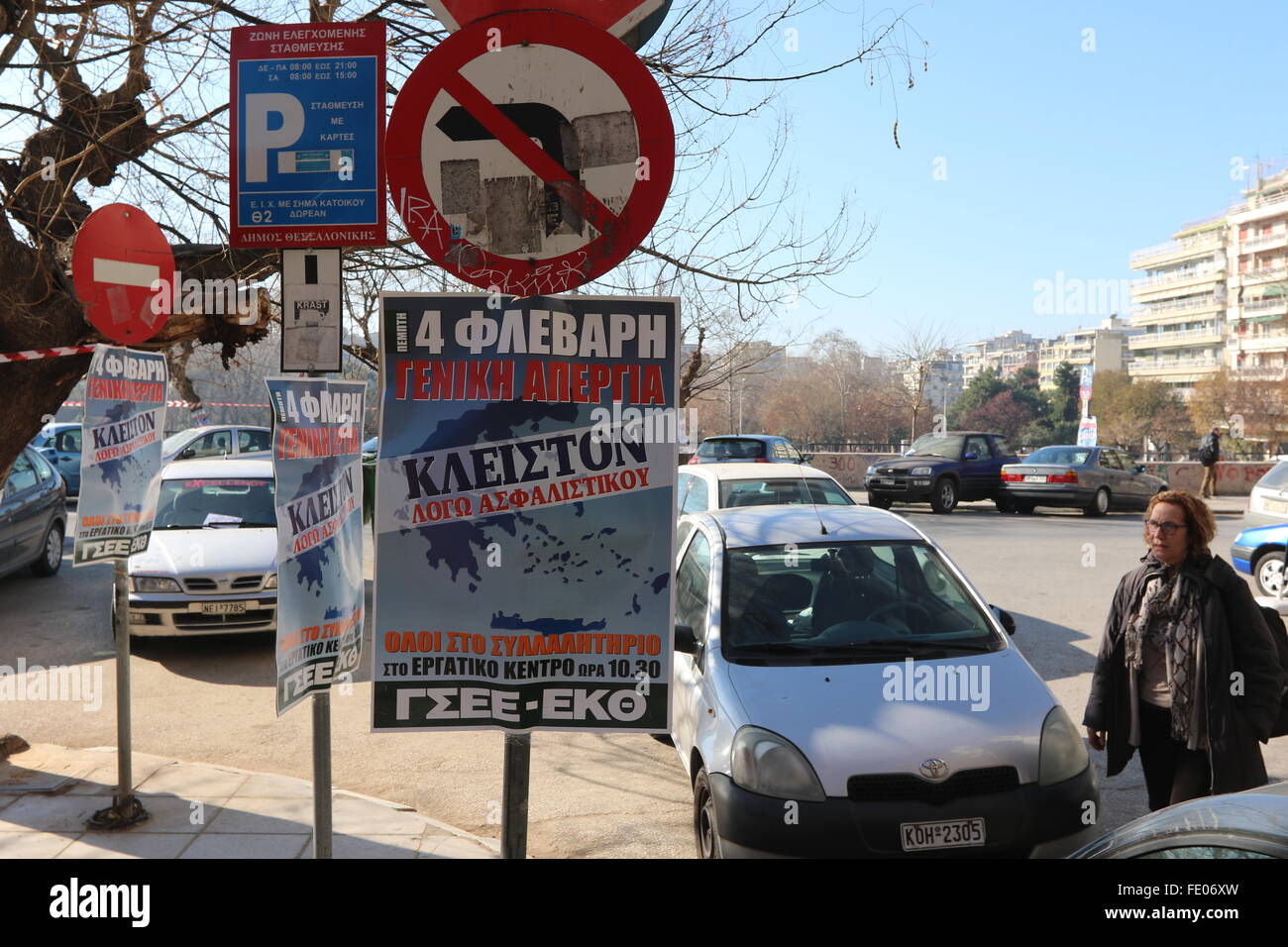Thessaloniki, Greece, 3 February 2016. A woman walks towards posters announcing a general strike and a rally. Greek public and private sector unions called for a nationwide general on Thursday to protest againts government's planned pension reforms that are part of the country's 3rd international bailout. Public transport is excepted to be severely disrupted, and taxi drivers are expected to join the action. Credit:  Orhan Tsolak/Alamy Live News Stock Photo