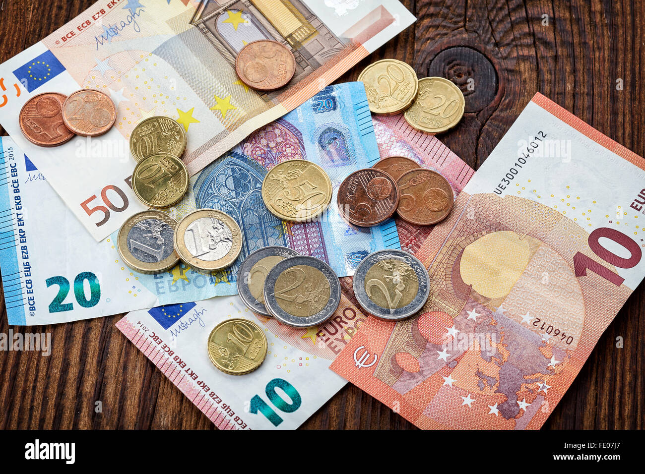 Money Euro banknotes and coins on wooden table, top view Stock Photo