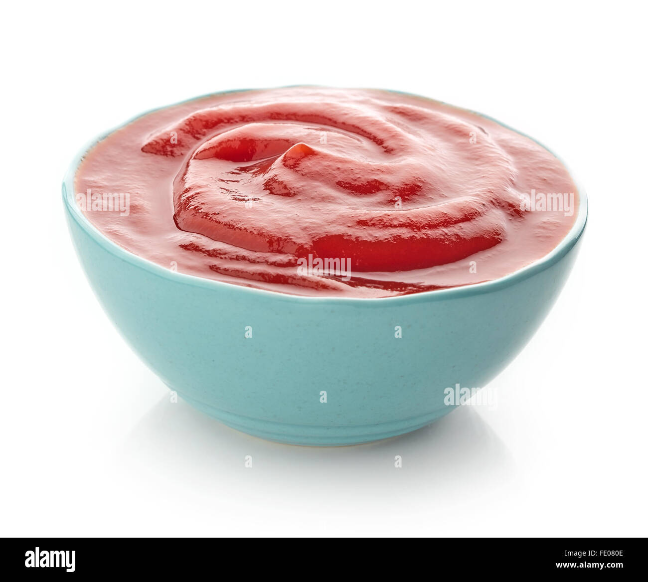Blue bowl of ketchup or tomato sauce on white background Stock Photo