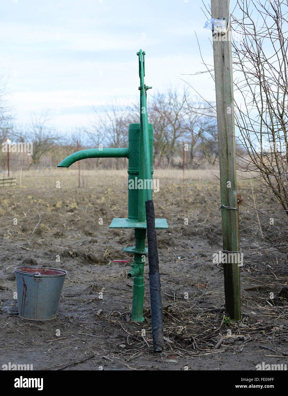 Hand pump leading to an artesian well. Pumping water for watering the