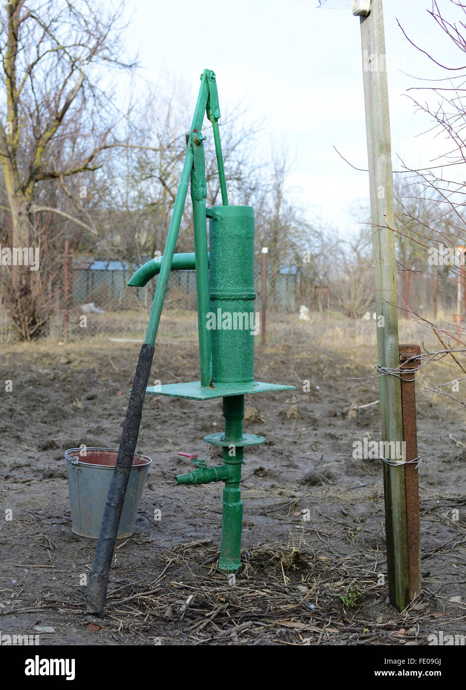 Hand pump leading to an artesian well. Pumping water for watering the