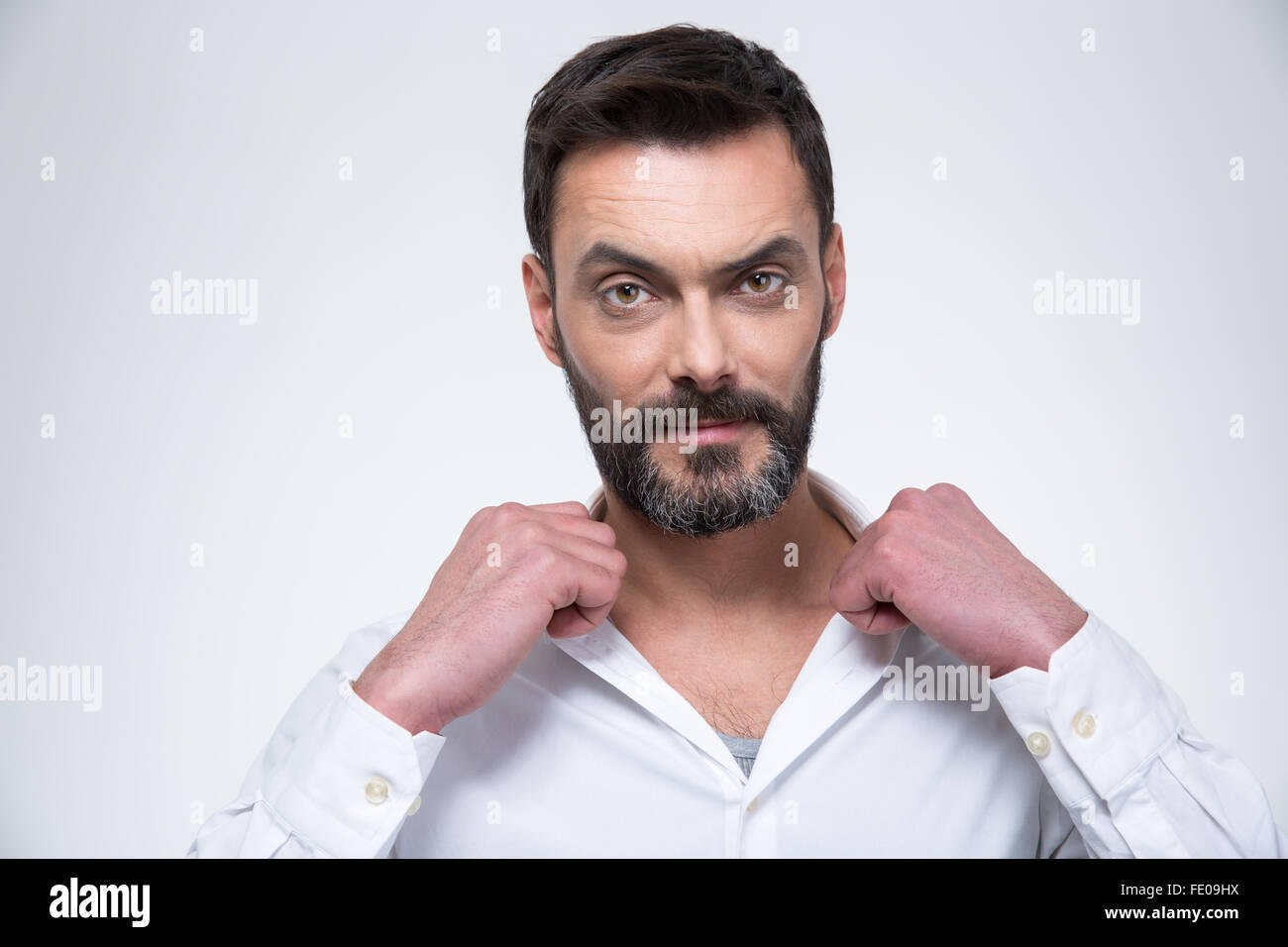 Confident businessman looking at camera isolated on a white background ...