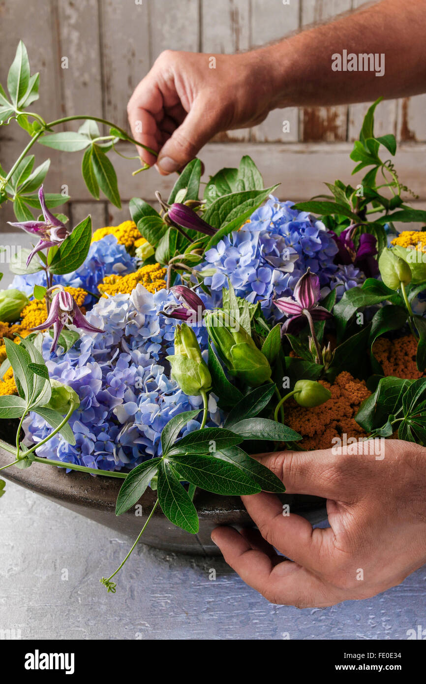 Florist shows how to make table decoration with hortensia flowers. Step by step, tutorial Stock