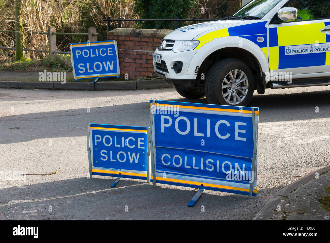 Police car and warning signs at a road traffic accident, Shifnal, Shropshire, England, UK. Stock Photo