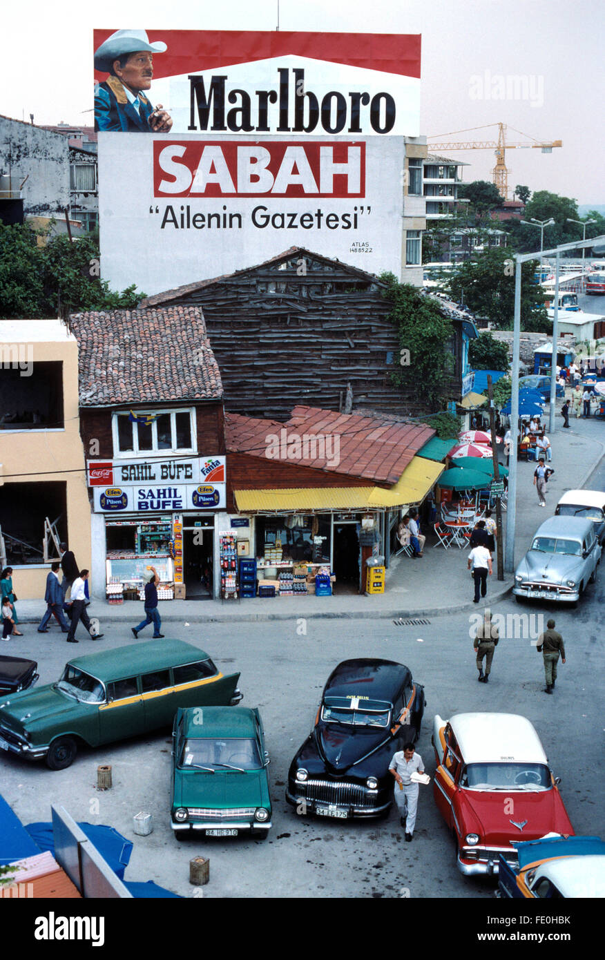 Istanbul Street Scene or Street View with Advertisement Hoardings Advertising Marlboro Cigarettes and the Turkish Daily Newspaper Sabah, and Vintage Dolmus or Collective Taxis, in the Fatih District, Istanbul, Turkey Stock Photo