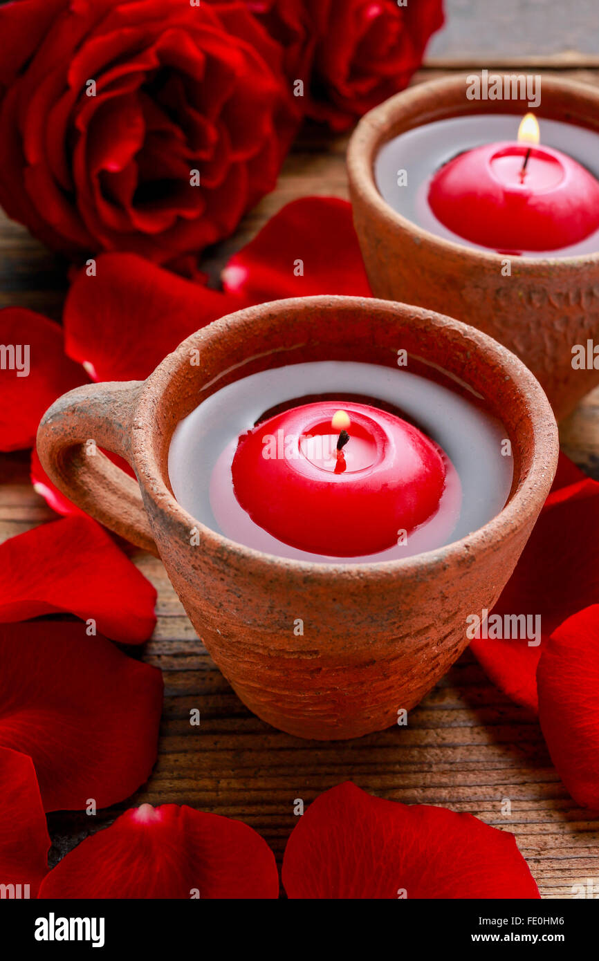 Floating candles in water among rose petals. Aromatherapy in spa Stock ...