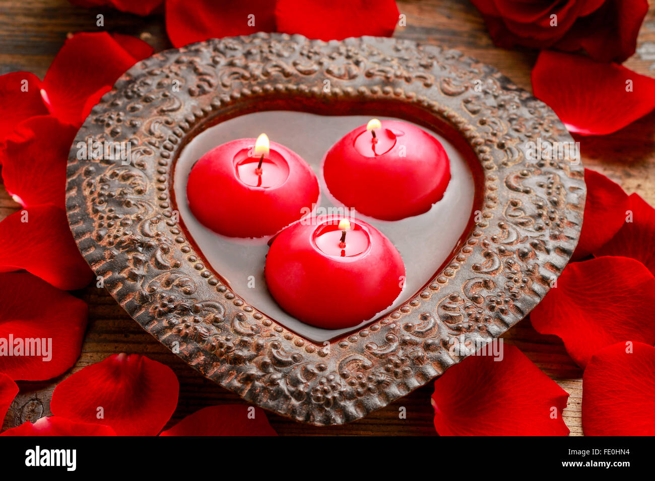 Floating candles in water among rose petals. Aromatherapy in spa Stock ...