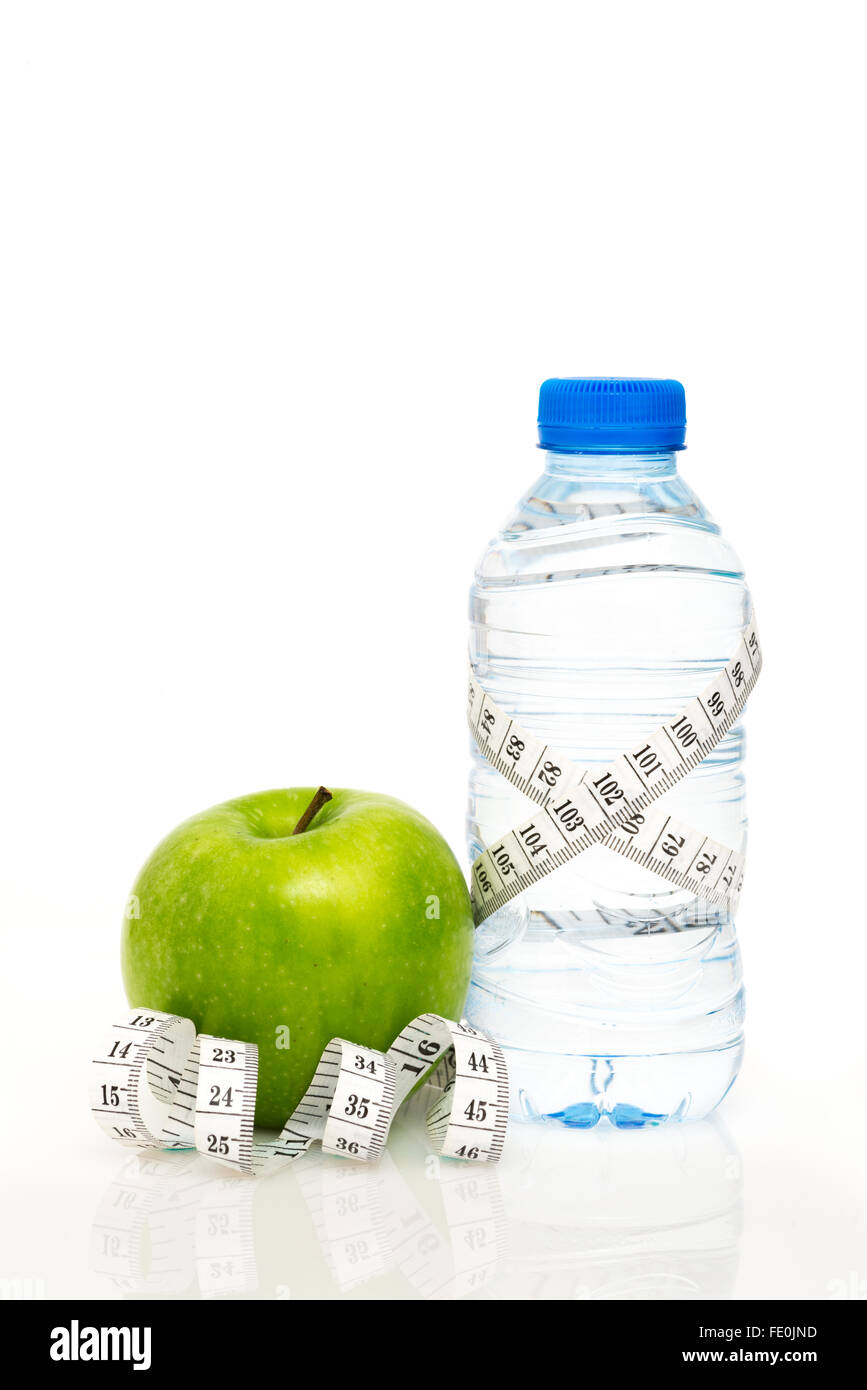 Water bottle wrapped in white metric tape measure with green apple