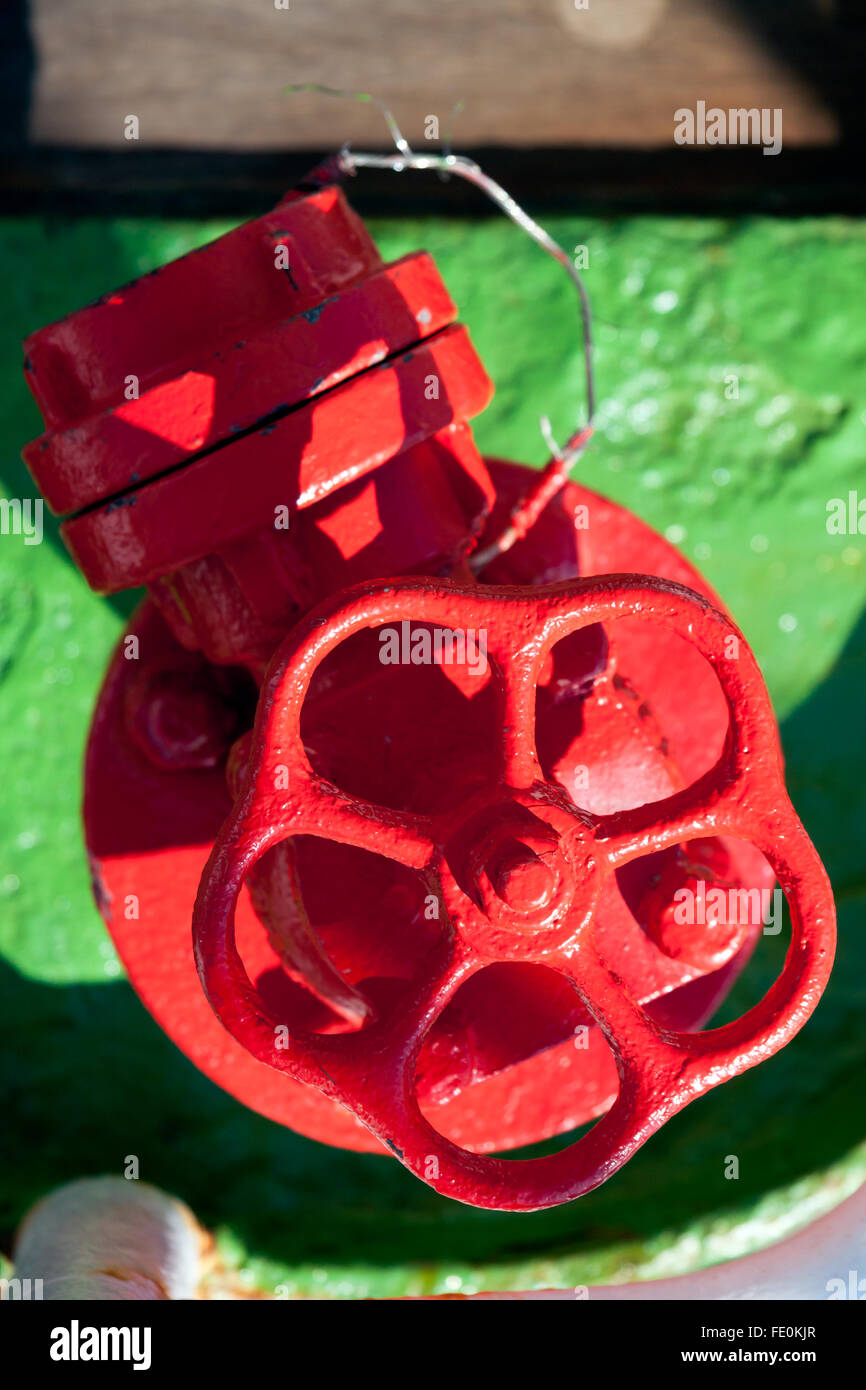 Red valve in pipeline installation Stock Photo