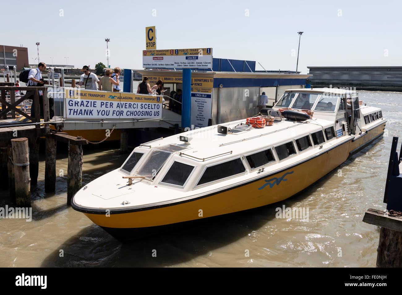 Visitors boarding a airport Vaporetto (water bus) that operate between