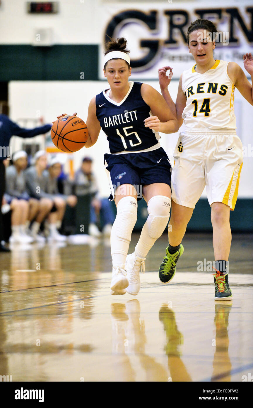 A high school player driving on the basket after negotiating past a defender as she moves into the lane. USA. Stock Photo