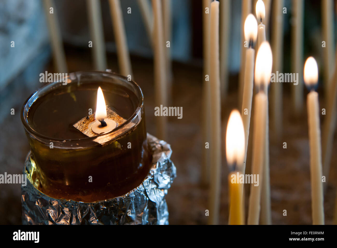 Church holy candle buring in oil. Sympol of faith, pray and meditation Stock Photo Alamy
