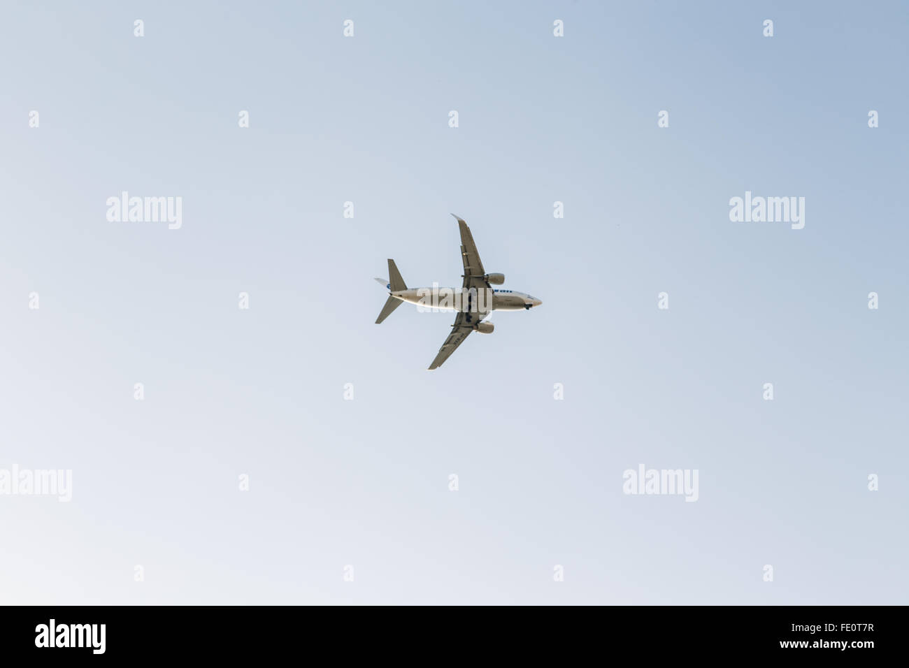 Plane flying in the blue sky Stock Photo - Alamy