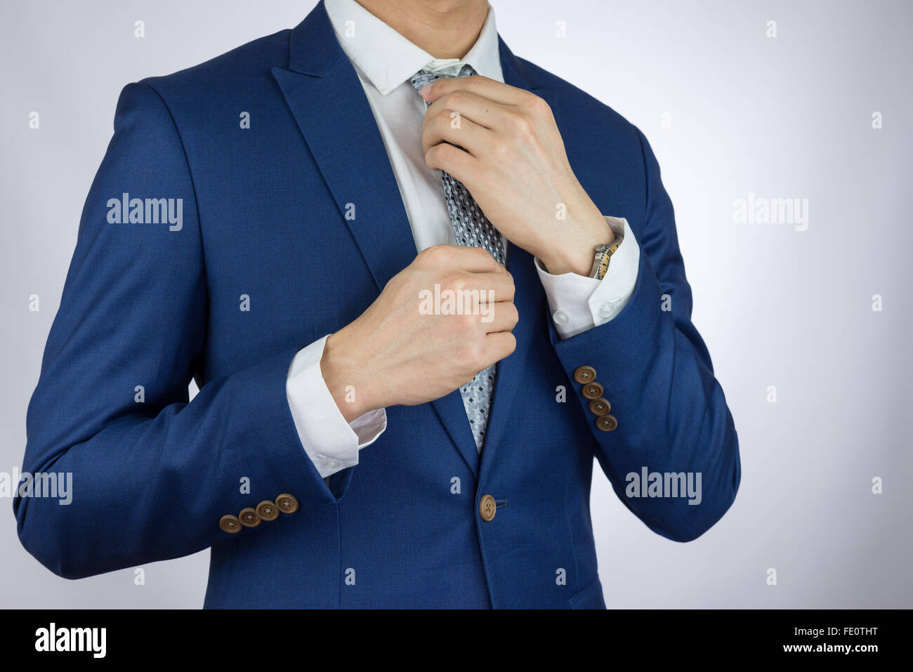 businessman fitting up blue suit and necktie Stock Photo