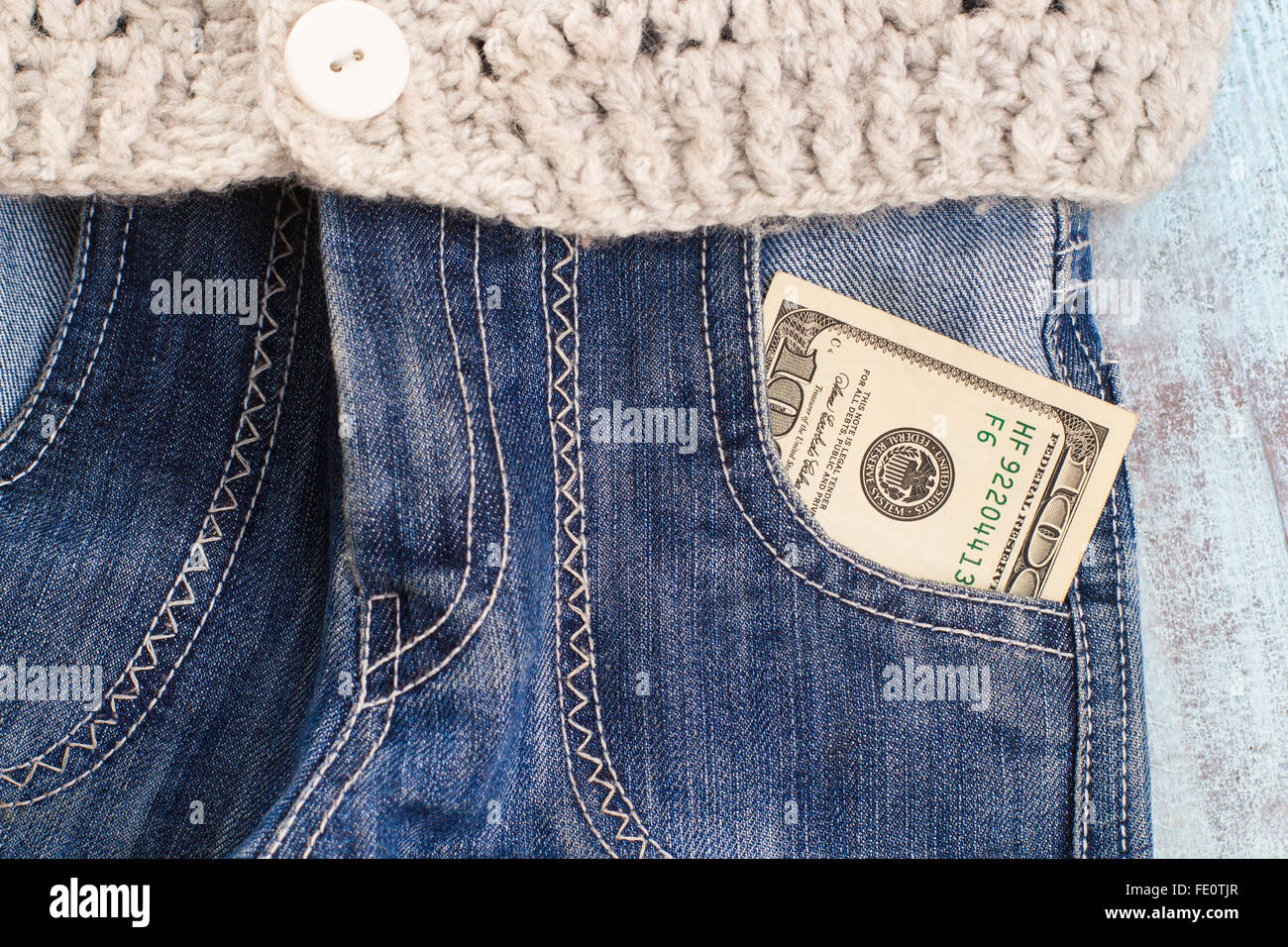 100 Dollars in jeans pocket Stock Photo