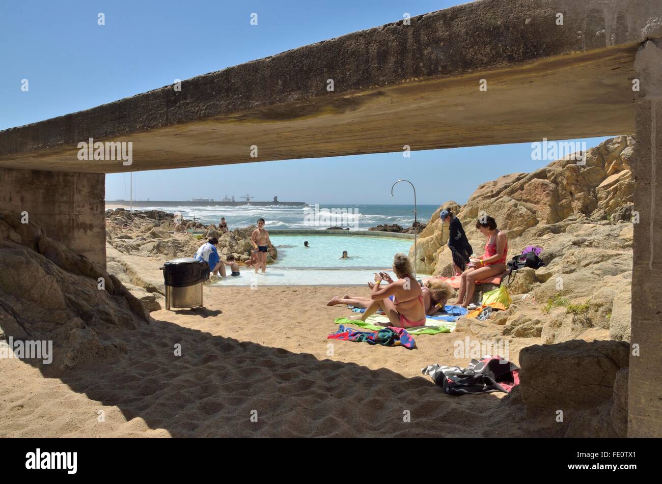 People at the natural swimming pools on the beach of Leca da Palmeira which is located north of the city of Matosinhos, in the d Stock Photo