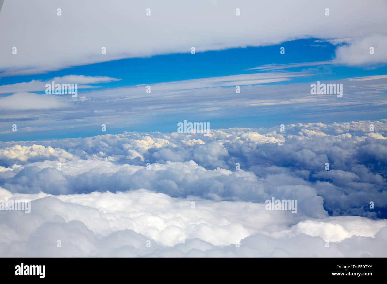 Aerial view of clouds and blue sky while flying on aircraft Stock Photo ...