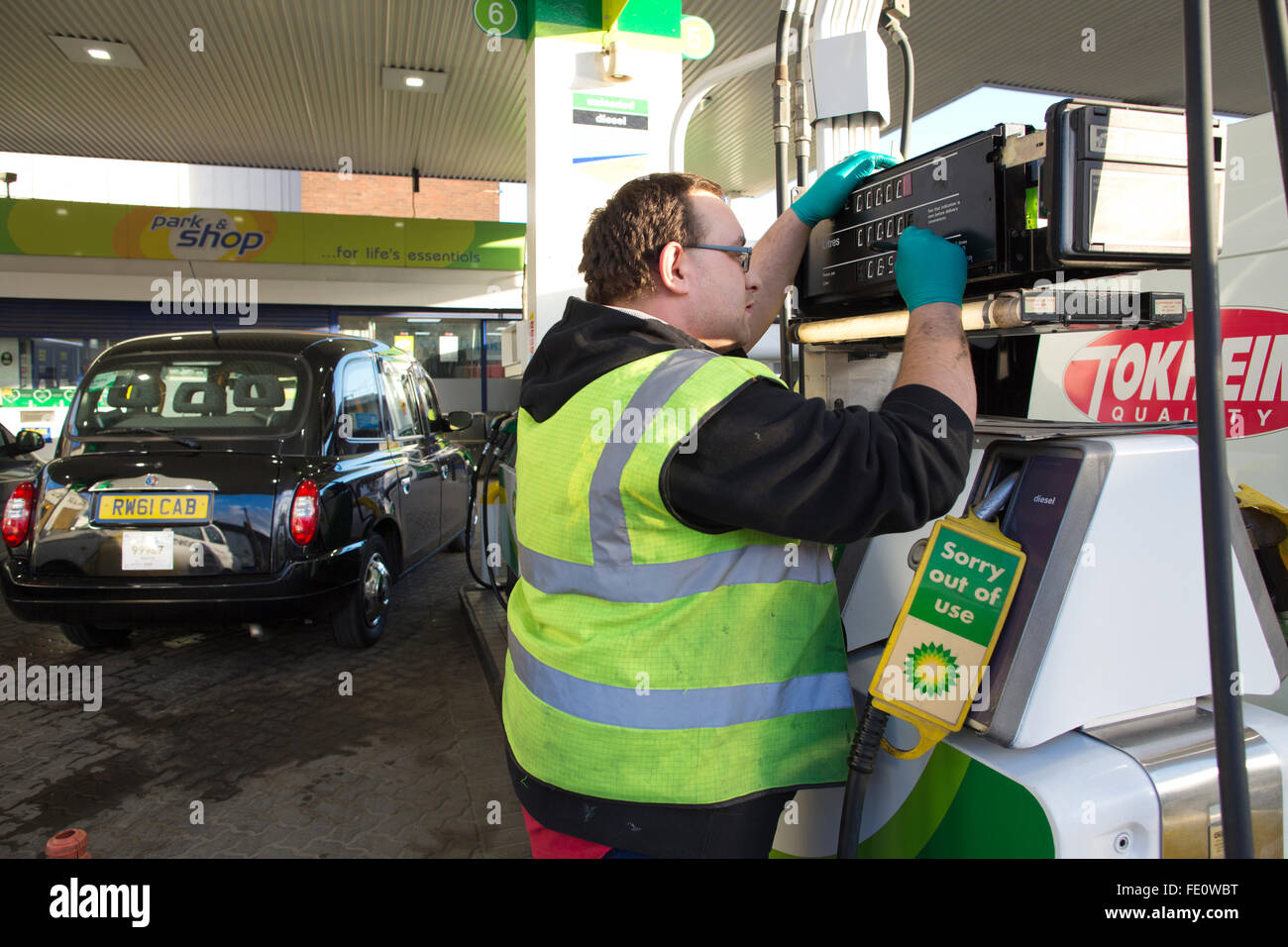 Technician Fixes A Counter Display At A British Petroleum Bp