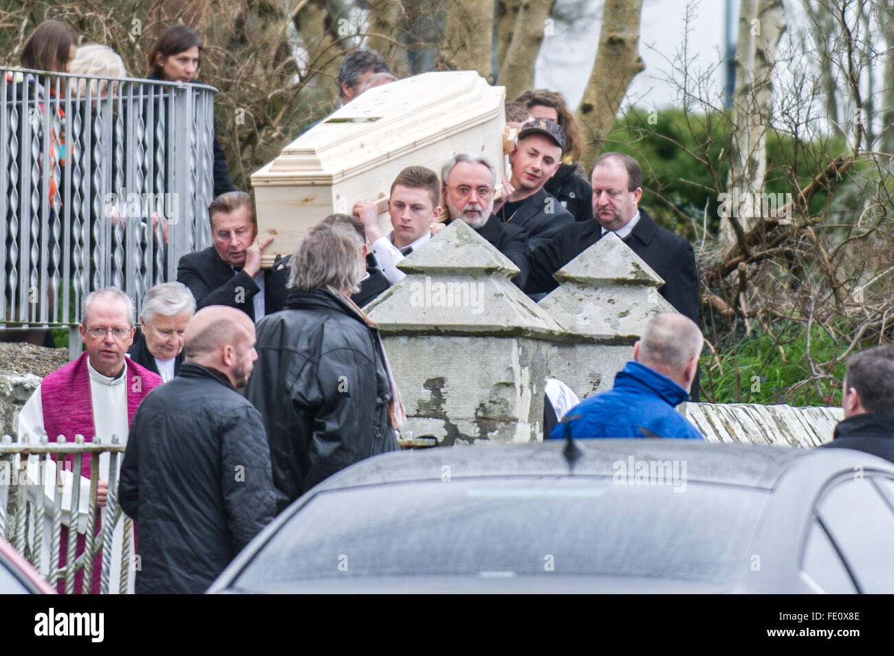 Schull, Ireland. 3rd February, 2016. Colin Vearncombe, aka 'Black' is shouldered from Holy Trinity Church, Schull by, amongst others, two of his sons and his manager, Steve Baker. He was carried to St. Mary's Church before leaving to await cremation on 4th February, 2016. Credit: Andy Gibson/Alamy Live News. Stock Photo