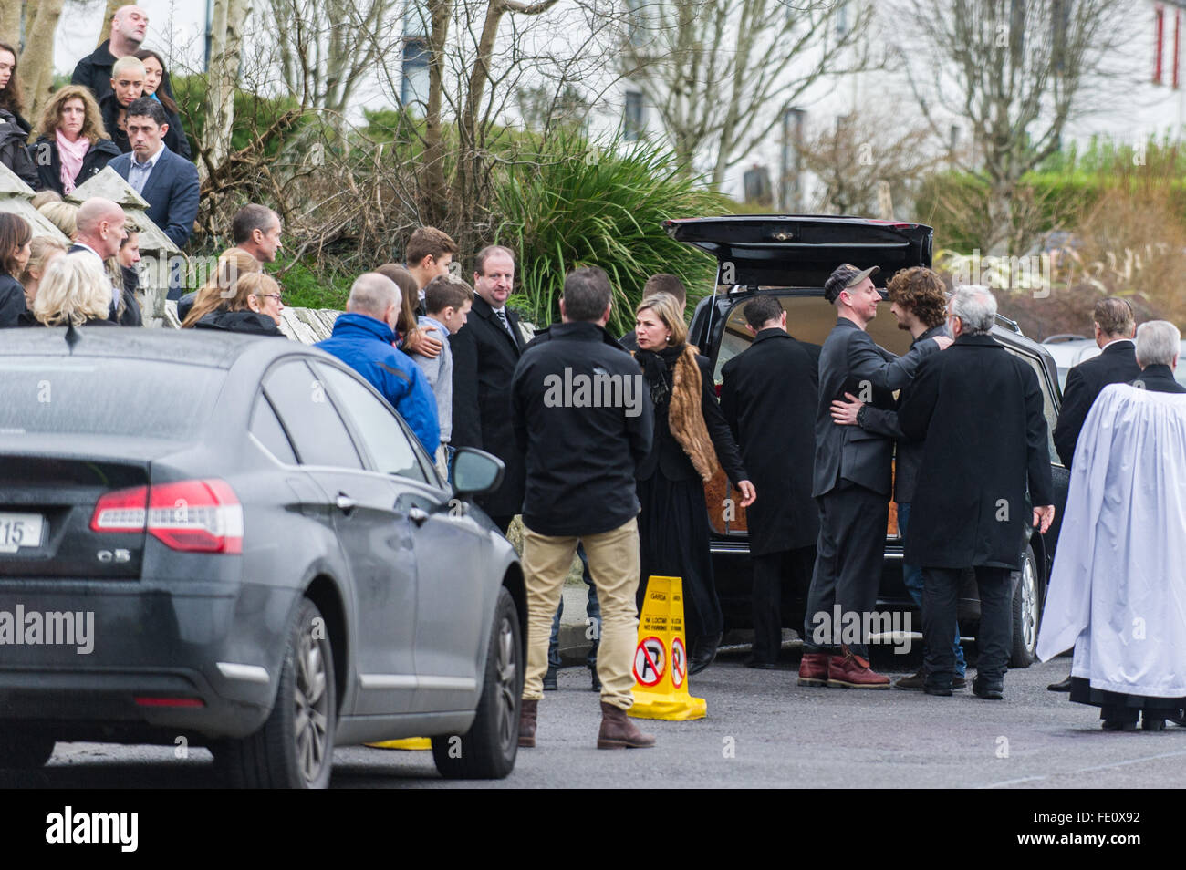 Schull, Ireland. 3rd February, 2016. The mourners console each other as Colin Vearncombe's coffin waits to be carried to St Mary's Church, Schull before leaving for cremation on 4th February, 2016. Credit: Andy Gibson/Alamy Live News. Stock Photo