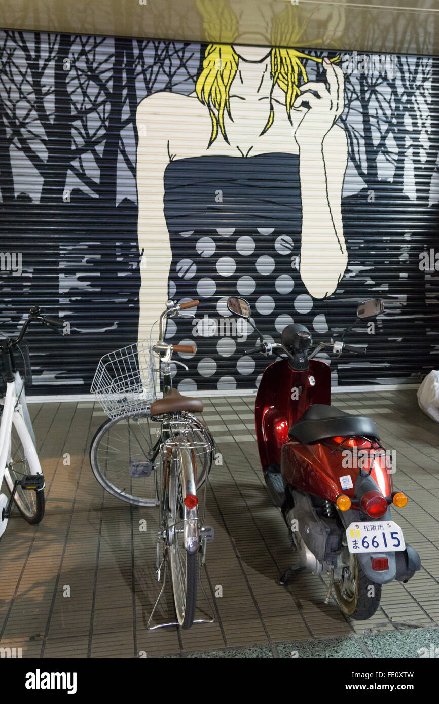 bicycles and scooter with painted backdrop in Japan Stock Photo