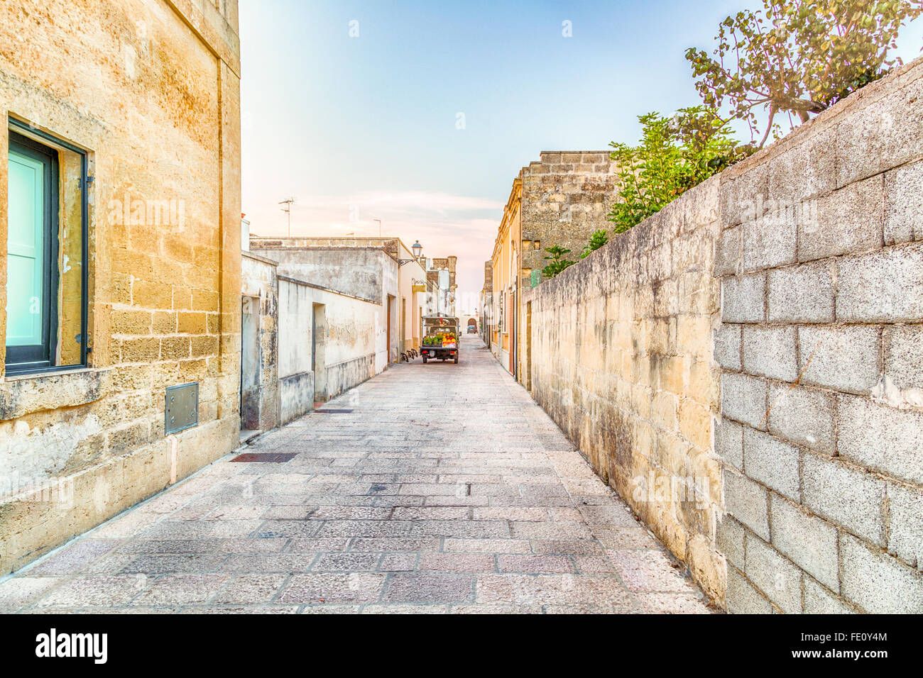 three-wheeled light commercial vehicle in the grid of streets and walls of fortified citadel of XVI century in Italy Stock Photo