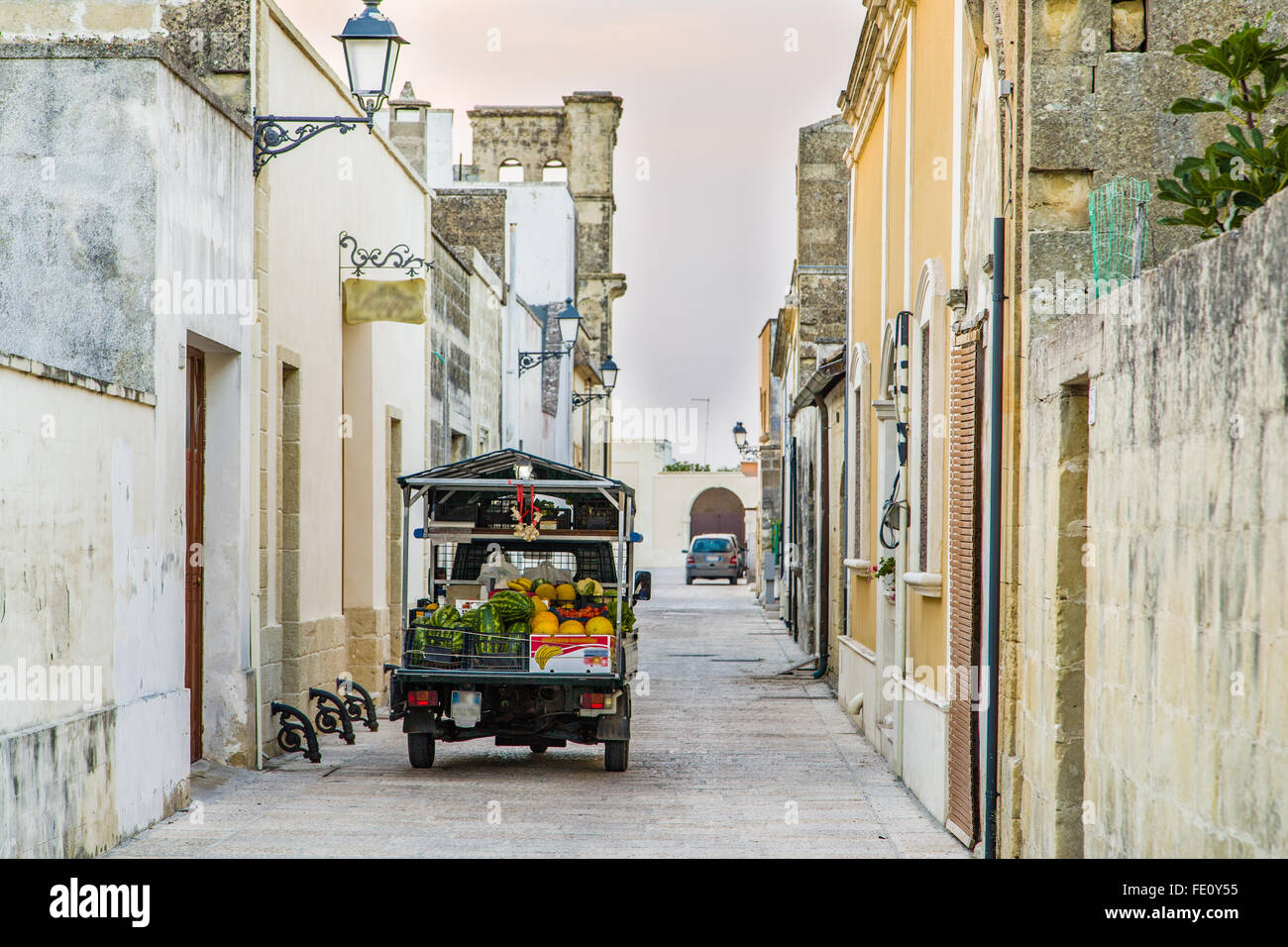 three-wheeled light commercial vehicle in the grid of streets and walls of fortified citadel of XVI century in Italy Stock Photo