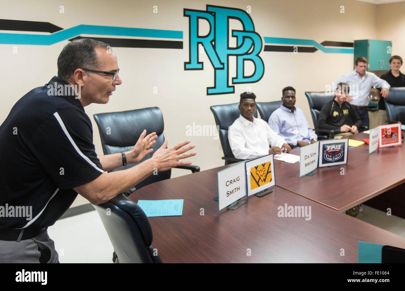 Royal Palm Beach, Florida, USA. 3rd Feb, 2016. Willie Bueno, (L), football head coach at Royal Palm Beach High speaks to friends and family members of Da'Von Brown (2L), Marlon Eugene,(2R), and Josh Carr, (R), during Signing Day at Royal Palm Beach High School February 03, 2016 in Royal Palm Beach. Brown a defensive back signed with Florida Atlantic University, Eugene, a linebacker signed with Southeast Missouri State University, and Carr, a quarterback signed with Harding University. © Bill Ingram/The Palm Beach Post/ZUMA Wire/Alamy Live News Stock Photo