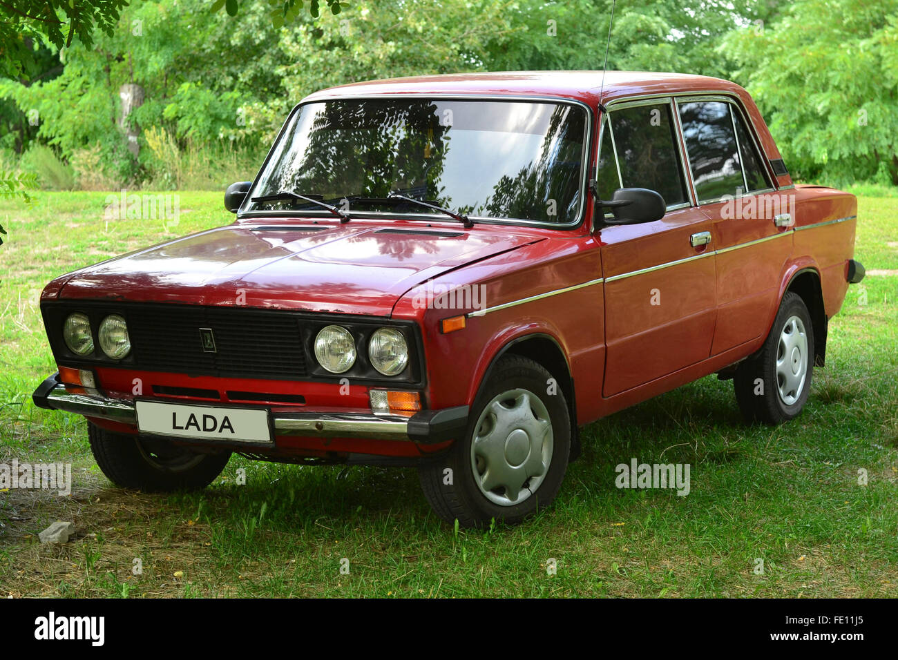 Red Soviet car Lada Vaz-1600 parked under the trees Stock Photo